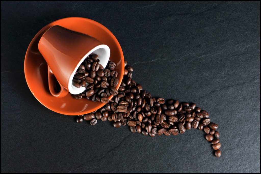 coffee beans spilling from cup